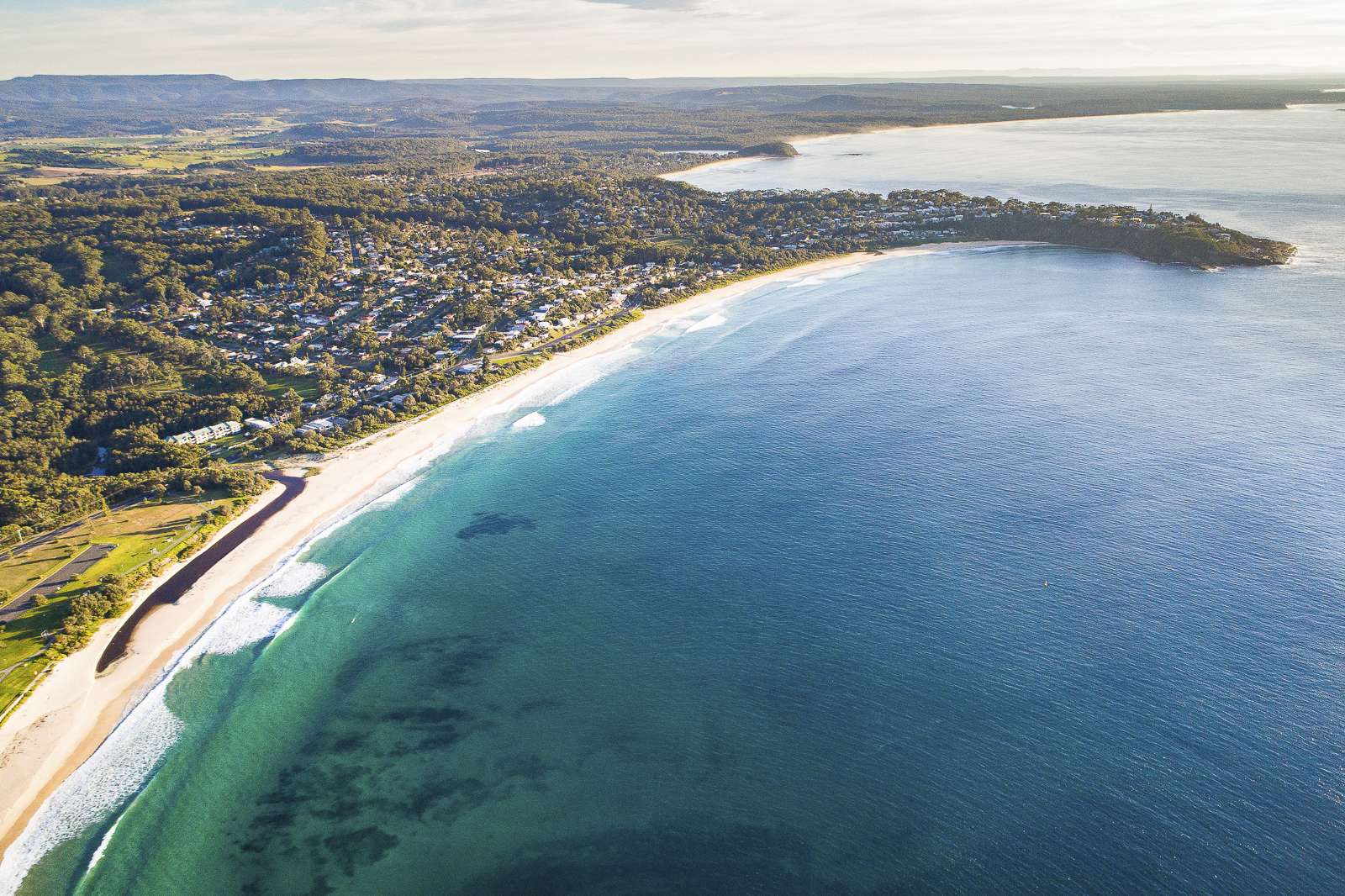 Aerial view of a coastal township and beach on the NSW South Coast