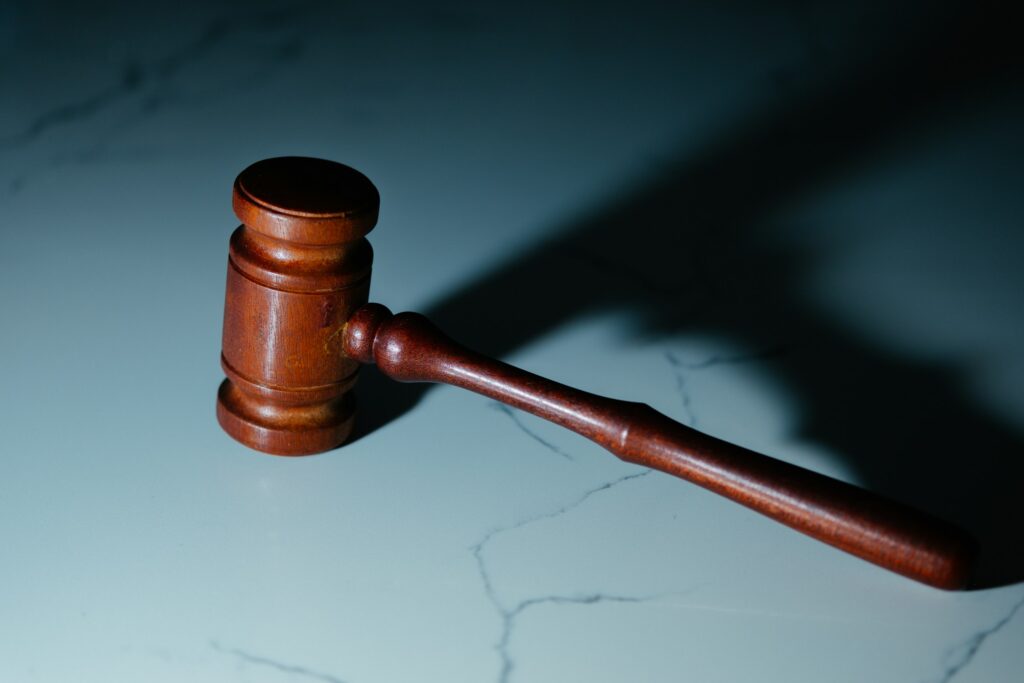An auctioneer gavel resting on a marble surface, representing bidding at a property auction