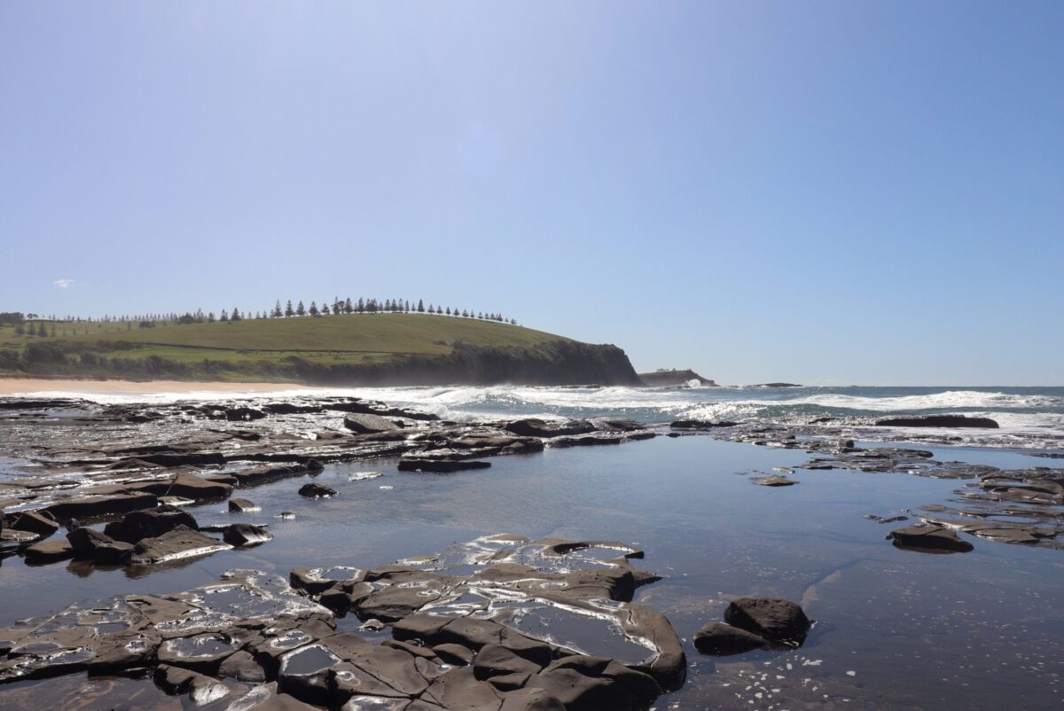 The rock shelf at Gerroa looking north to the grassy headland above the village