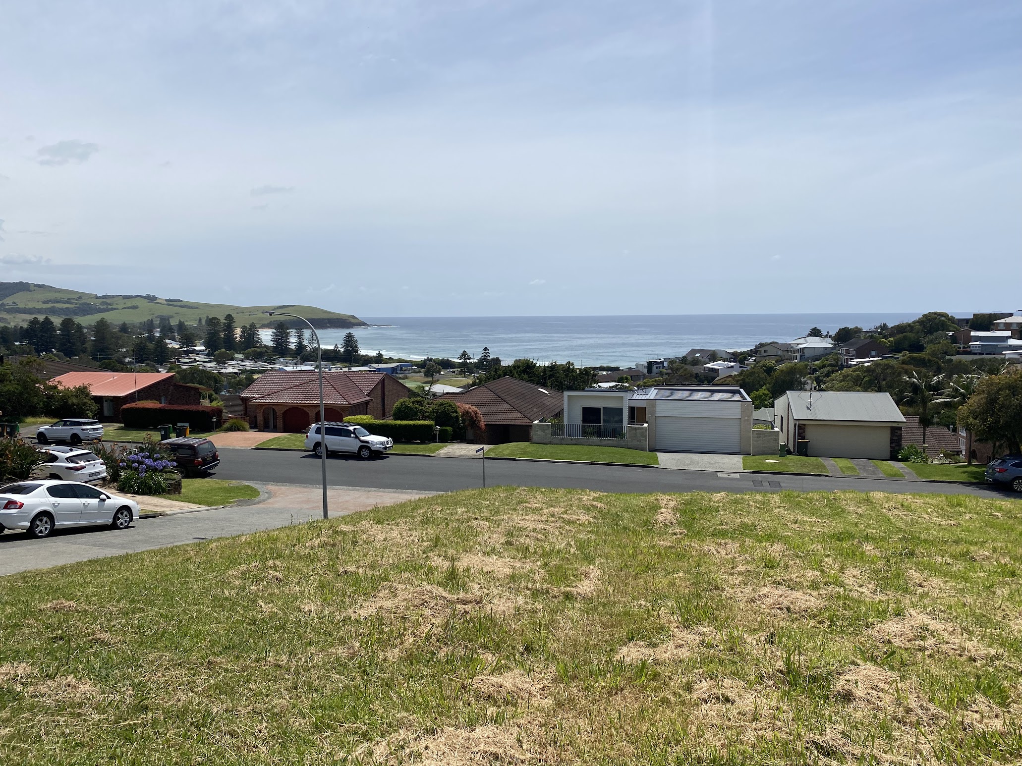 A vacant block at Gerringong looking over rooftops to Werri Beach