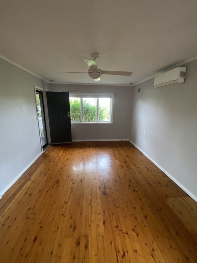 Empty living room with polished timber floors, ready for sale